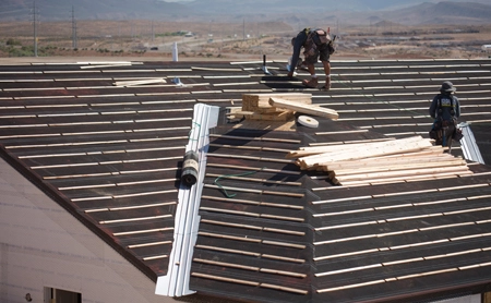 Roofing crew laying underlayment provided by Fontana Paper Mills